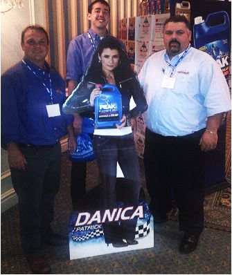 Dennis K. Burke, Boston employees around a Danika Patrick cardboard cutout advertising PEAK products