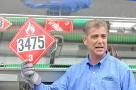 Matt Manoli holding up a hazardous materials tag