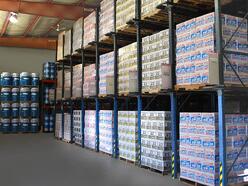 Warehouse racks stocked with various engine lubricants