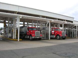 Two fueling trucks being filled up