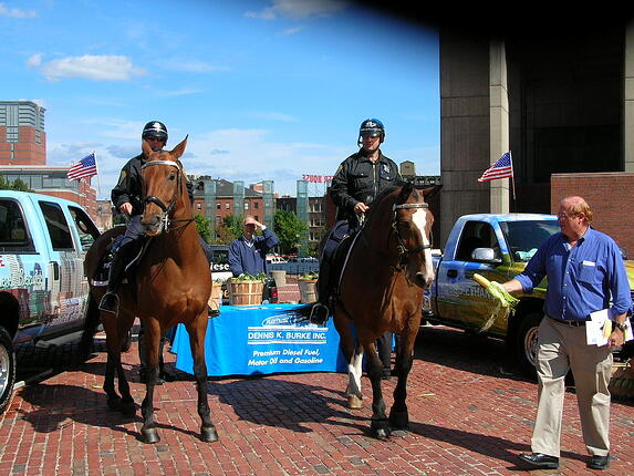 Police officers riding on horses pose infront of the Dennis K. Burke kiosk