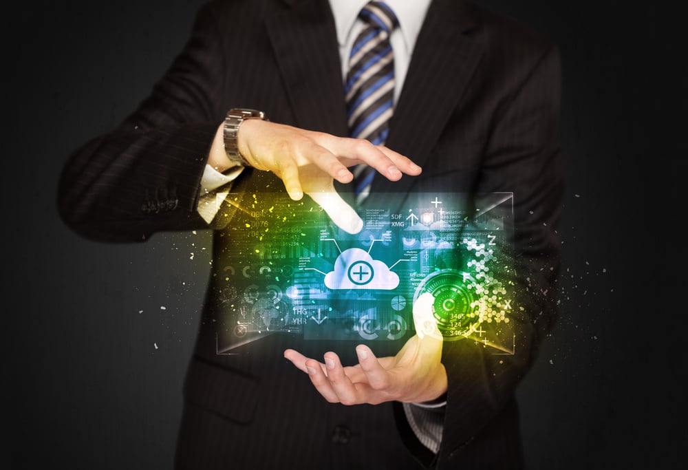 Businessman holding a shining data cloud in front of his body Businessman holding a shining data cloud in front of his body