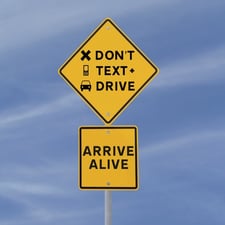 Road sign reading, Don't text and drive, arrive alive.