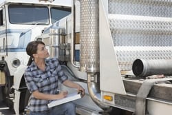 Woman performing a truck safety inspection