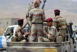 Soldiers on the back of a pickup truck 