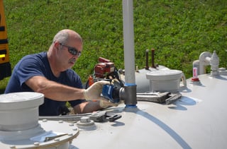 Technician installing a tank meter