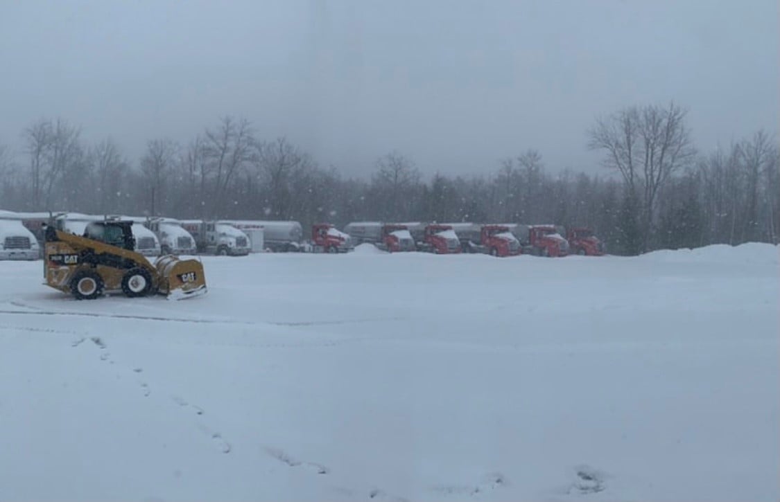 picture of trucks in snowy truck yard 