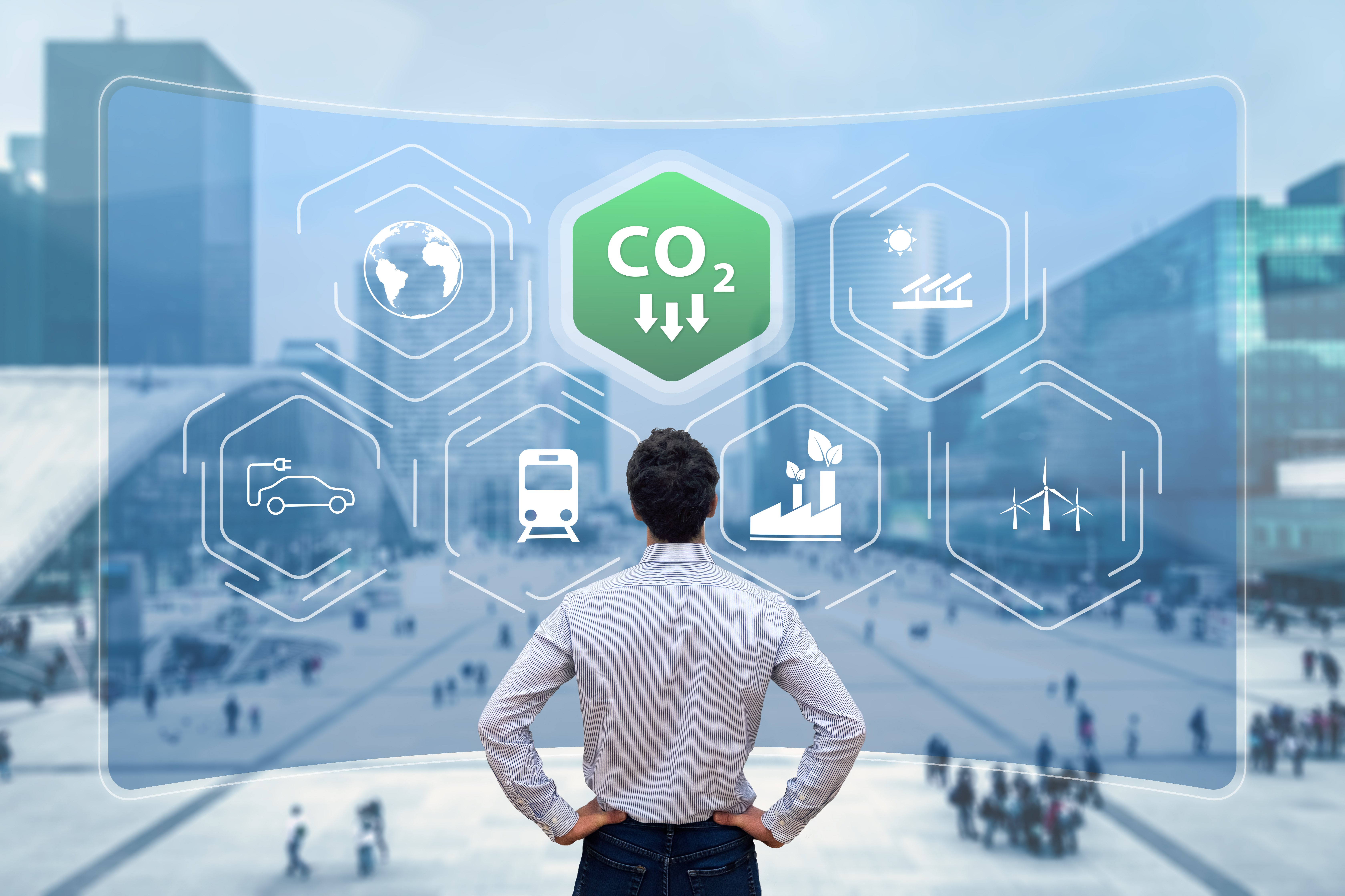 man looking at a screen with transportation modes pictured and an icon indicating CO2 levels