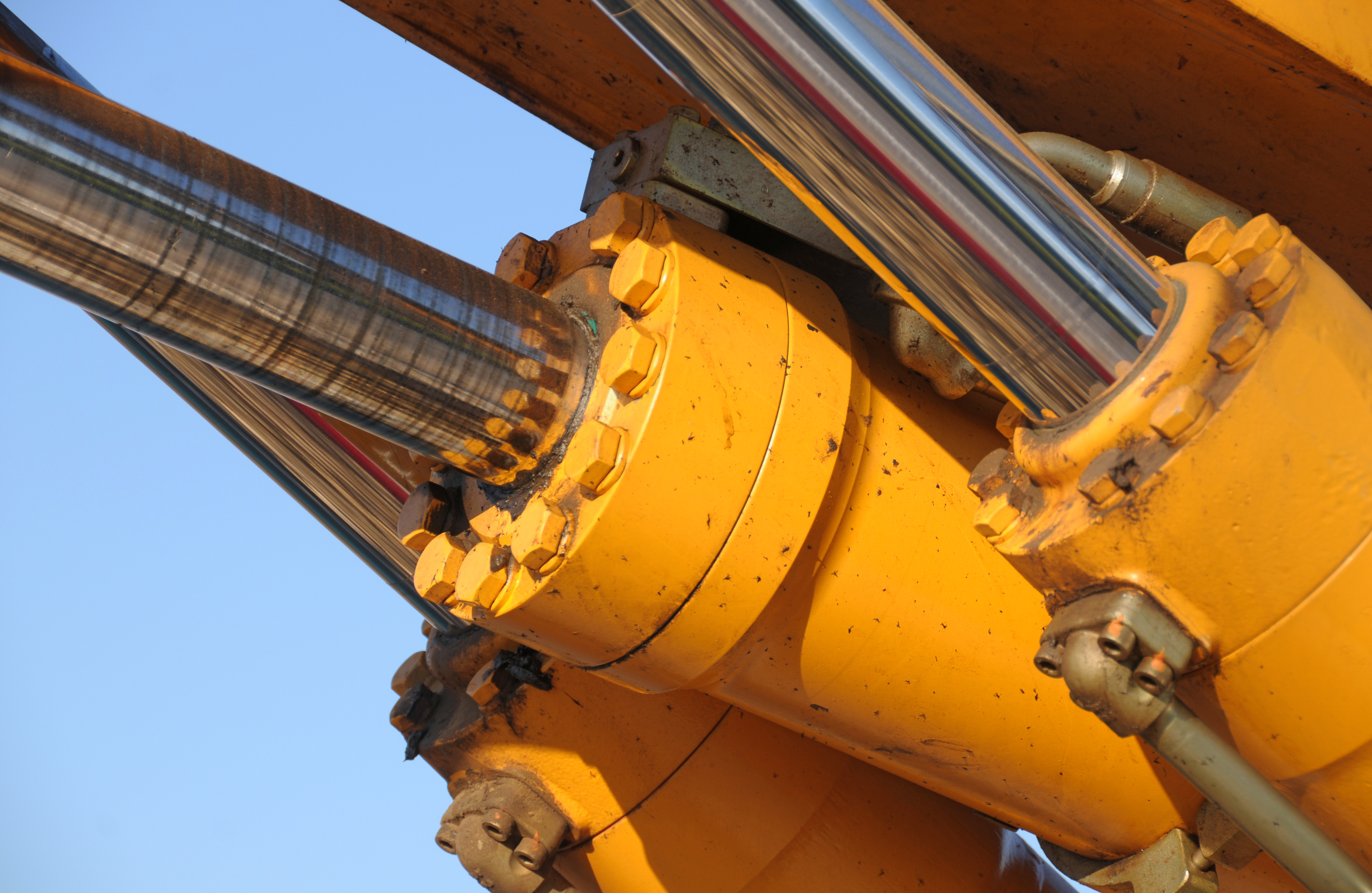 image of a piston in a yellow heavy duty piece of equipment